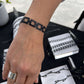 Customer Wearing Chain Reaction Bicycle Tube Bracelet™ on Wrist at Outdoor Market | Sustainable Fashion Jewelry | Kaden & Kai