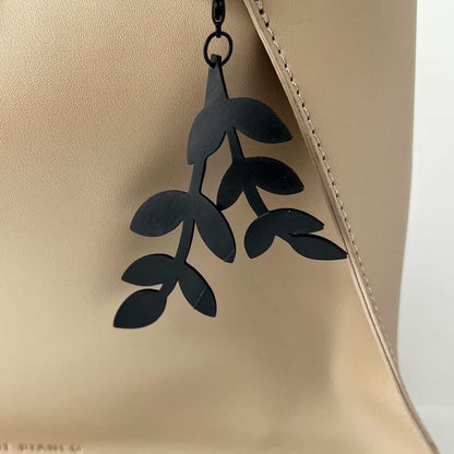 Close-up of Cascading Vine Bicycle Tube Key Chain on Handbag | Sustainable Fashion Bag Charm | Kaden & Kai