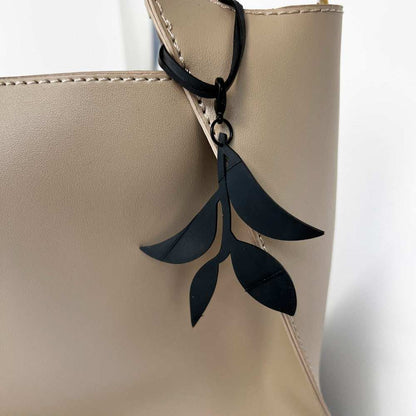 Close-up of Olive Branch Bag Charm on Handbag | Sustainable Fashion Accessory | Vine Collection |Kaden & Kai