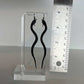 Snake Charm Bicycle Tube Earrings on Stand against ruler | Sustainable Fashion Earrings | Kaden & Kai